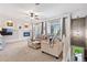 Cozy living room featuring a fireplace, balcony access, and views of the staircase leading to another level at 474 Black Feather Loop # 419, Castle Rock, CO 80104