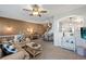 Comfortable living room with a ceiling fan, neutral carpet, and a view to the dining area and kitchen at 474 Black Feather Loop # 419, Castle Rock, CO 80104