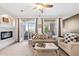 Bright and airy living room featuring a fireplace, large windows, and comfortable seating arrangements at 474 Black Feather Loop # 419, Castle Rock, CO 80104