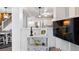 Open-concept living area showcasing a stylish console table, a staircase, and a seamless transition to the kitchen at 474 Black Feather Loop # 419, Castle Rock, CO 80104
