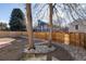 Backyard with a wooden fence, trees, gravel landscaping, and view of the neighbor's home at 9333 Cattail Ct, Highlands Ranch, CO 80126