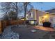 Backyard featuring gravel and stone landscaping, small patio with grill, and wood fence at 9333 Cattail Ct, Highlands Ranch, CO 80126