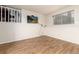 Finished basement area with laminate flooring, natural light, and ample open space at 9333 Cattail Ct, Highlands Ranch, CO 80126