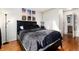 Cozy bedroom featuring sleek black furnishings, neutral walls, and decorative wall art at 9333 Cattail Ct, Highlands Ranch, CO 80126