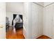 Bright bedroom boasts sleek hardwood floors, white walls, and a modern closet space at 9333 Cattail Ct, Highlands Ranch, CO 80126
