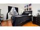 Primary bedroom boasts a large window, hardwood floors, and decorative art above the bed at 9333 Cattail Ct, Highlands Ranch, CO 80126