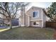 Charming home boasts a well-maintained exterior with lush lawn, mature trees, and lovely windows at 9333 Cattail Ct, Highlands Ranch, CO 80126