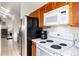 A kitchen featuring white countertops, a black refrigerator, and wooden cabinets at 9333 Cattail Ct, Highlands Ranch, CO 80126