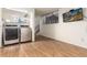 Laundry area with modern appliances and staircase access, illuminated by recessed lighting at 9333 Cattail Ct, Highlands Ranch, CO 80126