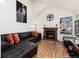 Bright living room featuring a red brick fireplace and comfortable leather sectional at 9333 Cattail Ct, Highlands Ranch, CO 80126