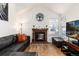 Bright living room featuring a red brick fireplace, and large window for natural light at 9333 Cattail Ct, Highlands Ranch, CO 80126