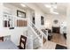 Spacious living room boasts tiled floors, modern staircase, white trim and a warm fireplace at 9333 Cattail Ct, Highlands Ranch, CO 80126