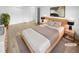 Virtually staged main bedroom with wood floors and double doors at 2685 S Dayton Way # 326, Denver, CO 80231