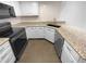 Kitchen with granite countertops and white cabinets at 2685 S Dayton Way # 326, Denver, CO 80231
