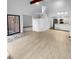 Open living room with vaulted ceiling, hardwood floors, and kitchen access at 2685 S Dayton Way # 326, Denver, CO 80231