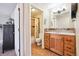 Bathroom features a wood vanity, tile floors, shower with bathtub, and updated finishes at 7984 Chase Cir # 68, Arvada, CO 80003