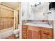 Bathroom features tile shower over tub, tile floors, wooden vanity, and neutral wall paint at 7984 Chase Cir # 68, Arvada, CO 80003