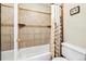 Bathroom showing bathtub with tile surround, toilet and framed artwork with neutral wall paint at 7984 Chase Cir # 68, Arvada, CO 80003