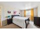 Cozy bedroom with a comfortable bed, window, and neutral walls adorned with decorative artwork at 7984 Chase Cir # 68, Arvada, CO 80003