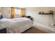 Comfortable bedroom with a cozy bed, window, and neutral walls, creating a relaxing atmosphere at 7984 Chase Cir # 68, Arvada, CO 80003