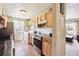 Functional kitchen with modern appliances, wood cabinetry, and an adjacent dining area at 7984 Chase Cir # 68, Arvada, CO 80003