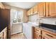 Convenient laundry area features a washer, dryer, window, and ample cabinet space for storage solutions at 7984 Chase Cir # 68, Arvada, CO 80003