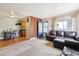 Open-concept living room with dining area, tile floors, and comfortable leather sofa at 7984 Chase Cir # 68, Arvada, CO 80003