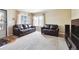 Inviting living room with plush carpet, ample natural light, and comfortable leather couches at 7984 Chase Cir # 68, Arvada, CO 80003
