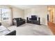 Cozy living room with neutral carpet, large window, and comfortable leather seating at 7984 Chase Cir # 68, Arvada, CO 80003