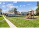 Community playground with green grass and a small slide at 7984 Chase Cir # 68, Arvada, CO 80003