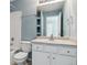 Bathroom with single sink vanity, shower/tub combo, and toilet at 9818 E Carolina Pl, Aurora, CO 80247