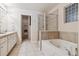 Relaxing bathroom featuring a soaking tub, separate shower, and ample storage space at 9818 E Carolina Pl, Aurora, CO 80247