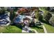 Aerial view of a community pool with a pergola, picnic tables, well-manicured landscaping, and an adjacent clubhouse at 9818 E Carolina Pl, Aurora, CO 80247