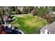 Aerial view of fenced dog park featuring a lush, green lawn, walking paths, and shaded seating areas near residences at 9818 E Carolina Pl, Aurora, CO 80247