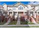 Brick front of charming townhome with stairs and landscaping at 9818 E Carolina Pl, Aurora, CO 80247
