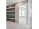 Hallway with built-in shelves and access to another room at 9818 E Carolina Pl, Aurora, CO 80247
