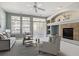 Comfortable living room featuring a fireplace and large windows for ample natural light at 9818 E Carolina Pl, Aurora, CO 80247