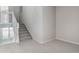 Carpeted staircase with white railing leading to the upper level of the home at 9818 E Carolina Pl, Aurora, CO 80247