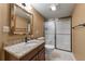 Bathroom featuring granite countertop, framed mirror, and a glass enclosed shower at 4927 Greenwich Way, Highlands Ranch, CO 80130
