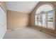 Bright bedroom features a large arched window with white shutters and a vaulted ceiling at 4927 Greenwich Way, Highlands Ranch, CO 80130