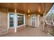 View of a wooden deck with brick accents and view of the property's surroundings at 4927 Greenwich Way, Highlands Ranch, CO 80130