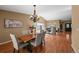 Cozy dining area with a wood table, upholstered chairs, and a view into the living room at 4927 Greenwich Way, Highlands Ranch, CO 80130