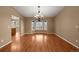 Dining room with hardwood floors, a chandelier, and a bay window with a backyard view at 4927 Greenwich Way, Highlands Ranch, CO 80130