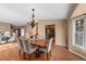 Open-concept dining room featuring stylish chairs, a wood table, and an elegant chandelier at 4927 Greenwich Way, Highlands Ranch, CO 80130