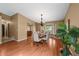 The dining room features a chandelier, bay window, and wood floors at 4927 Greenwich Way, Highlands Ranch, CO 80130