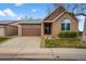 Charming single-Gathering brick home featuring a garage with decorative windows and a manicured lawn at 4927 Greenwich Way, Highlands Ranch, CO 80130