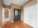 Home foyer features a dark wood door, wood floors, and closet for storing coats at 4927 Greenwich Way, Highlands Ranch, CO 80130
