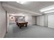 Large game room featuring pool table, carpeted floor and drop ceiling at 4927 Greenwich Way, Highlands Ranch, CO 80130