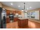Modern kitchen with stainless steel appliances, granite countertops, and wood cabinets at 4927 Greenwich Way, Highlands Ranch, CO 80130