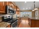 Modern kitchen with stainless steel appliances, granite countertops, and island with sink at 4927 Greenwich Way, Highlands Ranch, CO 80130